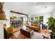 Open-concept living area with hardwood floors, leading to a kitchen with a spacious island at 10975 Hutcheson Ferry Rd, Chattahoochee Hills, GA 30268