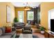 Relaxing living room with cozy fireplace, soft seating, and an abundance of natural light at 10975 Hutcheson Ferry Rd, Chattahoochee Hills, GA 30268