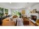 Bright and spacious living room with fireplace, hardwood floors, and double doors to the backyard at 10975 Hutcheson Ferry Rd, Chattahoochee Hills, GA 30268