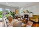 Comfortable living room offers a fireplace, hardwood floors, and convenient backyard access at 10975 Hutcheson Ferry Rd, Chattahoochee Hills, GA 30268