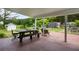 Brick patio with picnic table and an outdoor seating area at 10975 Hutcheson Ferry Rd, Chattahoochee Hills, GA 30268