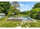 An outdoor area features a pristine in-ground pool with a hot tub at 10975 Hutcheson Ferry Rd, Chattahoochee Hills, GA 30268