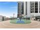 Outdoor basketball court on rooftop with seating areas and high-rise buildings in the background at 1280 W Peachtree Nw St # 1013, Atlanta, GA 30309