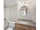 Well-lit bathroom featuring a granite countertop, oval mirror and shower with white tile at 1280 W Peachtree Nw St # 1013, Atlanta, GA 30309