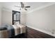 This bedroom features dark wood floors, large windows, and a modern ceiling fan at 1280 W Peachtree Nw St # 1013, Atlanta, GA 30309