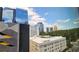 This exterior shot shows a building view with other buildings in the background and a blue sky at 1280 W Peachtree Nw St # 1013, Atlanta, GA 30309