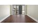Spacious room featuring dark hardwood floors, white trim, and a large window, offering stunning city views at 1280 W Peachtree Nw St # 1013, Atlanta, GA 30309