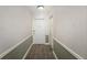 Inviting hallway featuring neutral wall colors, patterned carpet, and a white entry door, leading into the home at 1280 W Peachtree Nw St # 1013, Atlanta, GA 30309
