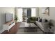 Inviting living room with modern decor, hardwood floors, and a large window providing ample natural light and city views at 1280 W Peachtree Nw St # 1013, Atlanta, GA 30309
