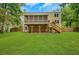 Expansive backyard view with a deck and screened porch, steps, and kayaks underneath, blending indoor and outdoor living at 1380 Heritage Glen Dr, Marietta, GA 30068