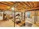 Unfinished basement featuring a treadmill, exposed rafters, and concrete floor at 1380 Heritage Glen Dr, Marietta, GA 30068
