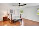 This bedroom features a four-poster bed, hardwood floors, ceiling fan and natural light at 1380 Heritage Glen Dr, Marietta, GA 30068