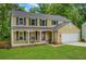 Inviting two-story home featuring a covered front porch and attached two-car garage at 1380 Heritage Glen Dr, Marietta, GA 30068