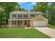 Charming two-story home boasts a well-manicured lawn and a welcoming front porch at 1380 Heritage Glen Dr, Marietta, GA 30068