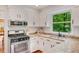 Updated kitchen features granite countertops, stainless sink, and stainless gas range at 1380 Heritage Glen Dr, Marietta, GA 30068