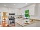 Bright renovated kitchen with granite counters, stainless gas range and view to the dining room at 1380 Heritage Glen Dr, Marietta, GA 30068