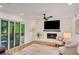 Inviting living room with a stone fireplace, large TV, and access to a screened porch at 1380 Heritage Glen Dr, Marietta, GA 30068