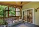 Serene screened porch with a comfortable swing, string lights, and a calming view for relaxing outdoors at 1380 Heritage Glen Dr, Marietta, GA 30068