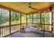 Relaxing screened porch features a cozy swing, ceiling fan and charming wooded view for enjoying the outdoors at 1380 Heritage Glen Dr, Marietta, GA 30068