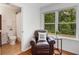 A sitting area with a view of the trees outside with an adjacent bathroom at 1380 Heritage Glen Dr, Marietta, GA 30068