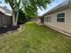 Manicured lawn in the backyard featuring black mulch beds, a privacy fence, and covered patio at 2586 Gristhaven Ln, Buford, GA 30519