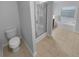 Bathroom features tiled floor, toilet and glass shower at 2586 Gristhaven Ln, Buford, GA 30519