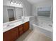 Bathroom features double sink vanity, soaking tub and large window at 2586 Gristhaven Ln, Buford, GA 30519