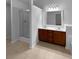 Bathroom features double sink vanity, and tiled shower with glass door at 2586 Gristhaven Ln, Buford, GA 30519