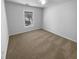 Clean and well lit bedroom featuring neutral walls and carpet at 2586 Gristhaven Ln, Buford, GA 30519