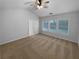 Spacious bedroom features neutral carpeting, ceiling fan and natural light from three windows at 2586 Gristhaven Ln, Buford, GA 30519