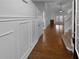 Elegant entryway features paneled walls, hardwood floors and leads to the living area at 2586 Gristhaven Ln, Buford, GA 30519