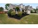 Charming two-story home featuring manicured landscaping, a lush lawn, and a welcoming front porch at 2586 Gristhaven Ln, Buford, GA 30519