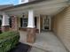 Inviting front porch with stone accents, columns, and a stylish entryway at 2586 Gristhaven Ln, Buford, GA 30519