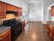 Kitchen with stainless steel appliances and wood cabinets, open to dining area at 2586 Gristhaven Ln, Buford, GA 30519