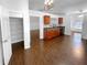 Open kitchen featuring wood cabinets and dark countertops over hardwood floors at 2586 Gristhaven Ln, Buford, GA 30519