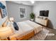 Comfortable primary bedroom featuring soft carpet, natural light, and a dresser with a wall mounted TV at 2586 Gristhaven Ln, Buford, GA 30519