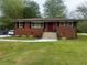 Charming brick home featuring a well-manicured lawn, new sidewalk, and a neatly landscaped front yard at 3731 Wisteria Se Ln, Smyrna, GA 30082