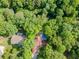 Overhead view of a charming home and lush green surroundings featuring mature trees and landscaping at 3809 Cotswold Sw Dr, Lilburn, GA 30047
