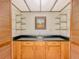 Charming bar area features a sink, storage cabinets and glass shelving at 3809 Cotswold Sw Dr, Lilburn, GA 30047