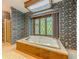 Bathroom featuring a sunken tub with a garden view window at 3809 Cotswold Sw Dr, Lilburn, GA 30047
