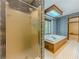 Bathroom with a shower and large tub with a garden view at 3809 Cotswold Sw Dr, Lilburn, GA 30047