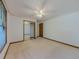 Bedroom featuring neutral carpet, white walls, window, and closet with sliding mirror doors at 3809 Cotswold Sw Dr, Lilburn, GA 30047