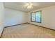 Sun-filled bedroom featuring neutral carpet, white walls, and a window at 3809 Cotswold Sw Dr, Lilburn, GA 30047