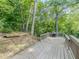 Spacious wooden deck perfect for grilling and outdoor entertaining, surrounded by lush greenery at 3809 Cotswold Sw Dr, Lilburn, GA 30047