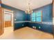 Traditional dining area featuring blue wallpaper, wood trim, and a chandelier for an elegant dining experience at 3809 Cotswold Sw Dr, Lilburn, GA 30047