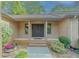 Inviting covered front entry with a double door, brick facade, and well-maintained landscaping at 3809 Cotswold Sw Dr, Lilburn, GA 30047
