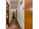 Hallway features hardwood floors and doors on each side at 3809 Cotswold Sw Dr, Lilburn, GA 30047