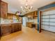 Bright kitchen with wood cabinets, white appliances, a desk, and abundant storage for cooking and entertaining at 3809 Cotswold Sw Dr, Lilburn, GA 30047