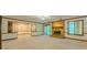 Spacious living room featuring a brick fireplace, large windows, and neutral carpet at 3809 Cotswold Sw Dr, Lilburn, GA 30047