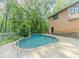 Inviting pool with stone trim in a private backyard setting, offering a serene escape at 3809 Cotswold Sw Dr, Lilburn, GA 30047